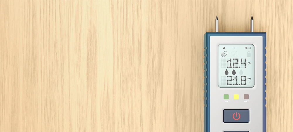 Digital moisture meter on a wooden desk, top view