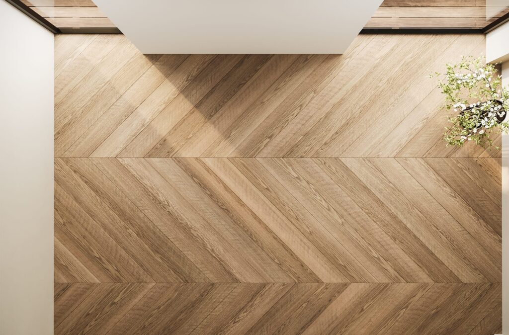 top view of an empty interior with chevron wood flooring, soft lighting, and minimal deco