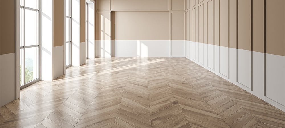 unfurnished living room with beige and white walls, floor to ceiling windows and parquet flooring