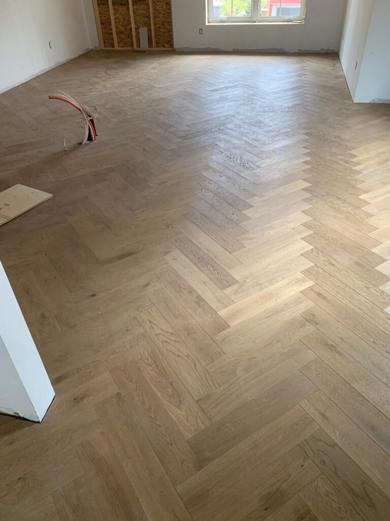 Hardwood herringbone floor installation in progress — LV Flooring Toronto
