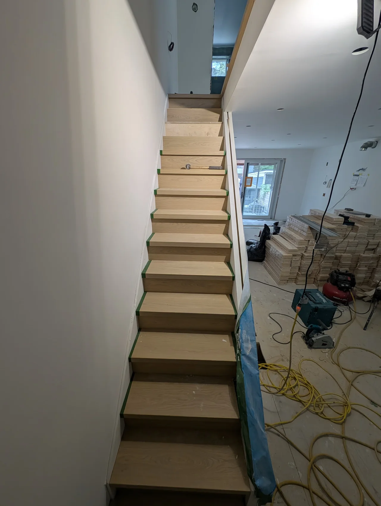 Stair flight with newly fitted treads and risers during installation